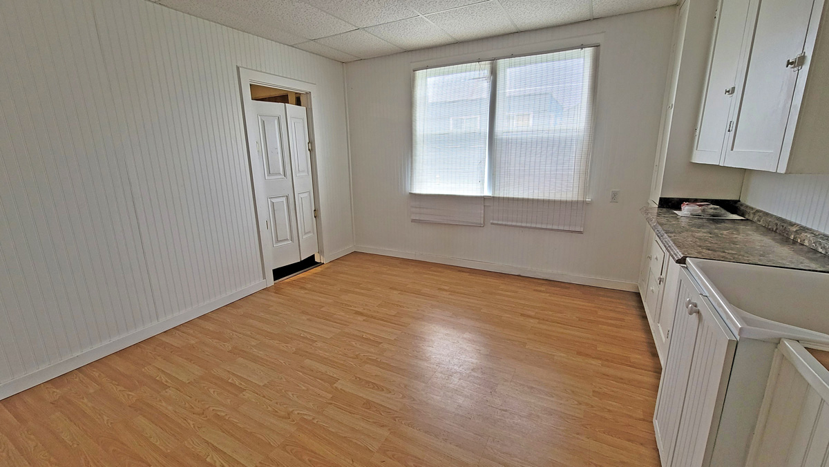 Downstairs room with hardwood floor and kitchenette